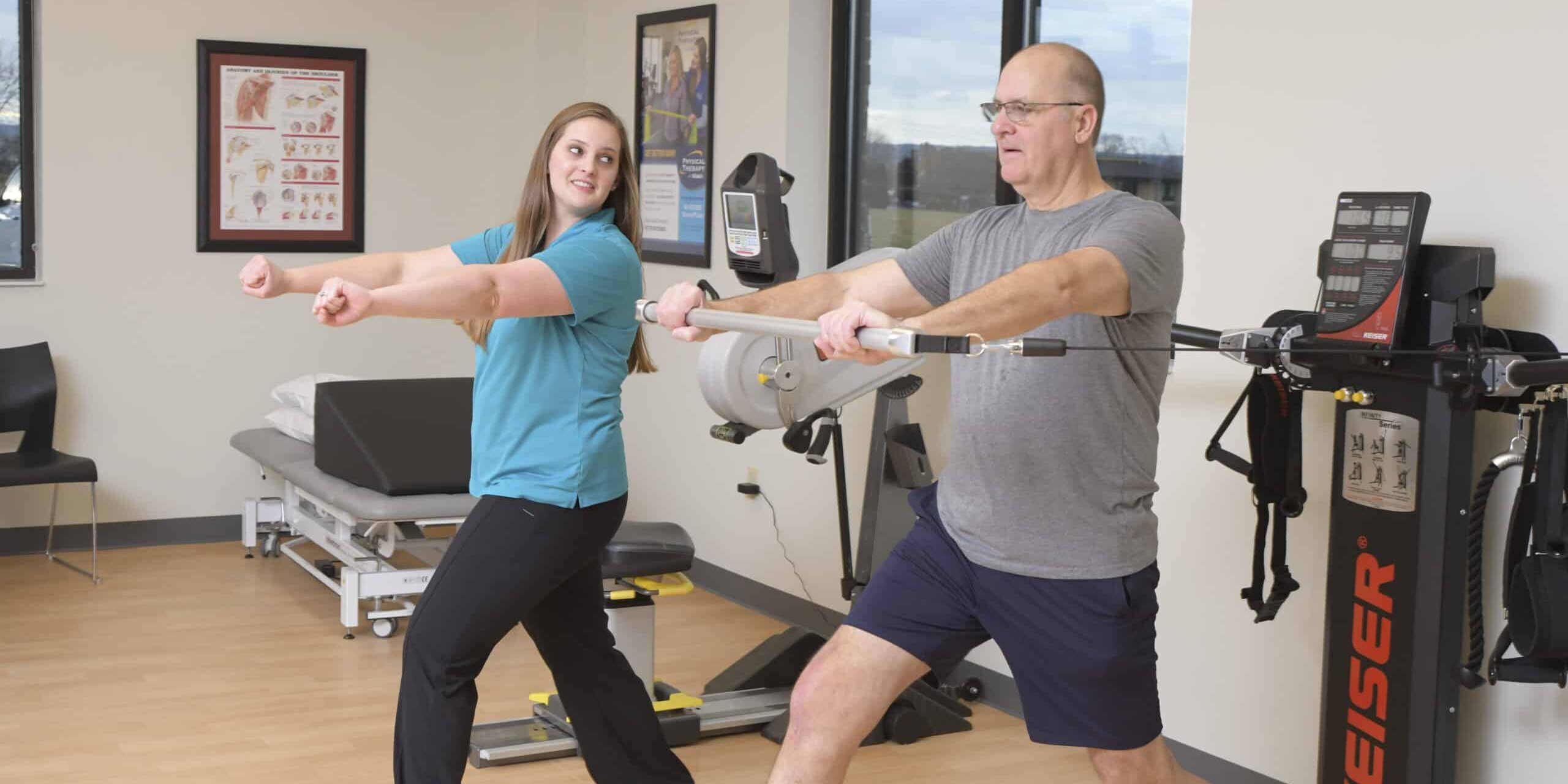 One of our expert physical therapists guides a patient through performing a strengthening exercise